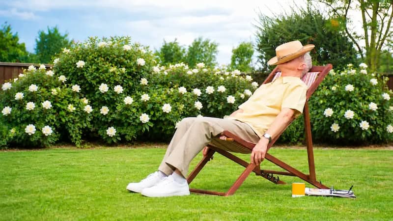 Homeowner relaxing on perfect lawn